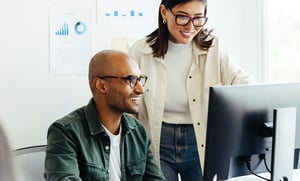 happy coworkers looking ay computer