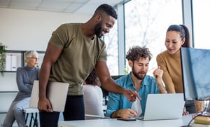 coworkers collaborating around desk