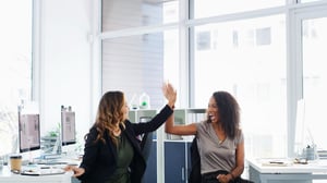 two onboarding reps celebrate the success of seamlessly onboarding new clients