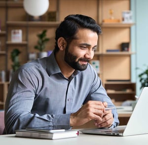 man-on-computer-smiling
